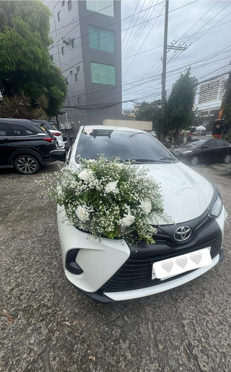 White Toyota Vios with wedding flowers on a Mandaue City street